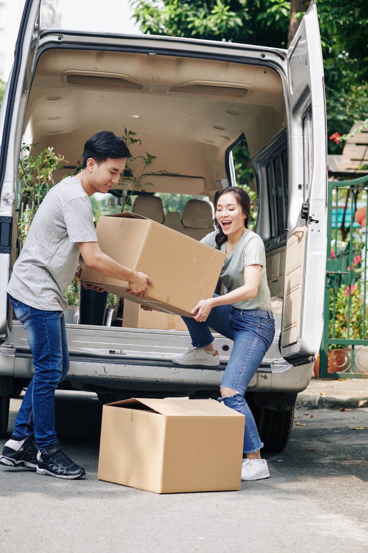 couple unloading card boxes from the truck