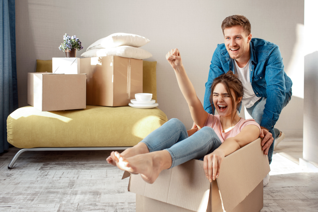 Couple packing moving boxes.