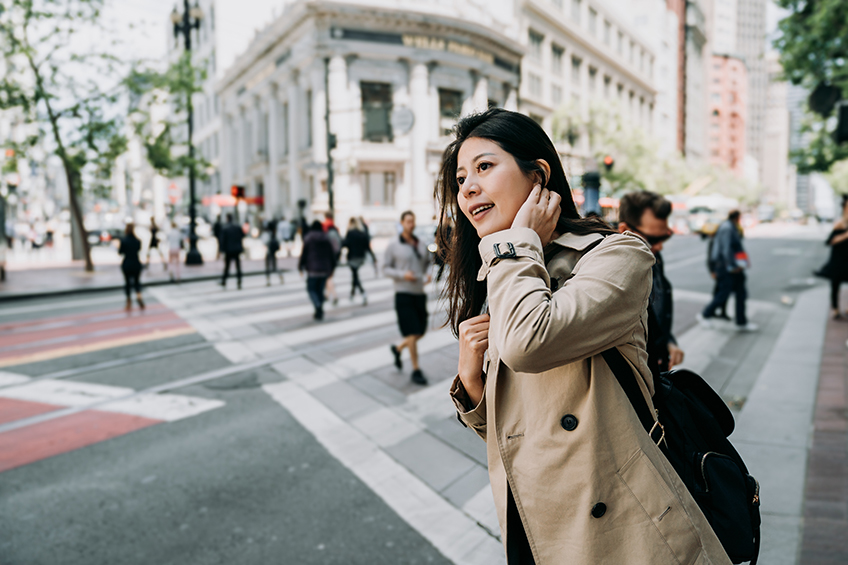 Woman standing on the street of a foreign country.