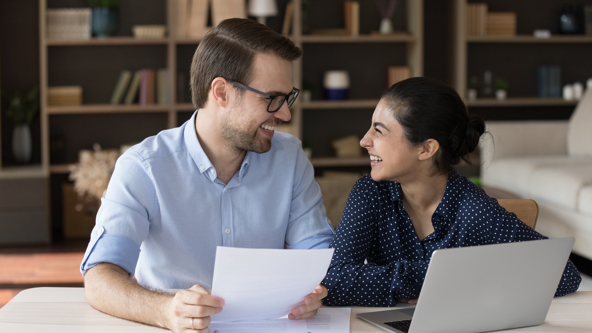 Couple working at a desk with paper and a computer