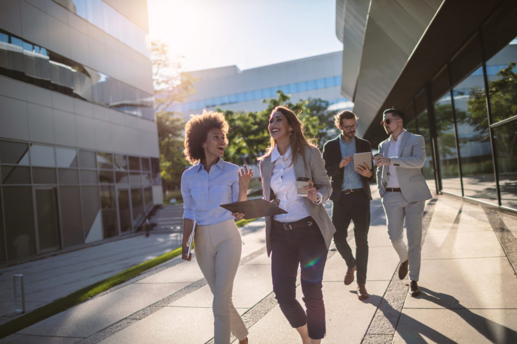 Corporate staff walking in front of office building